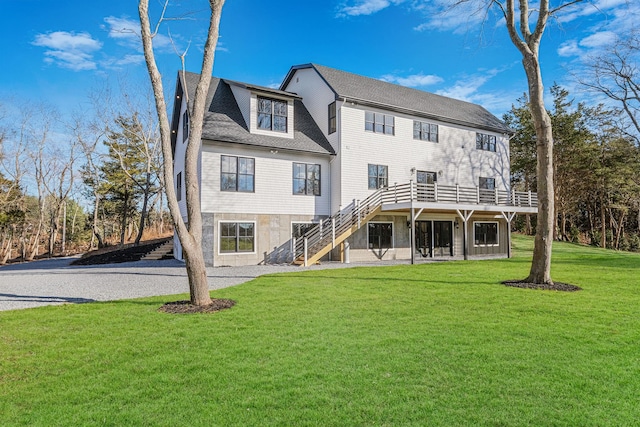 back of property featuring a yard and a wooden deck