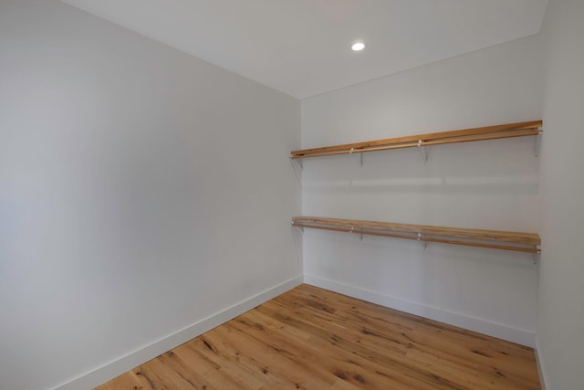 walk in closet with hardwood / wood-style floors