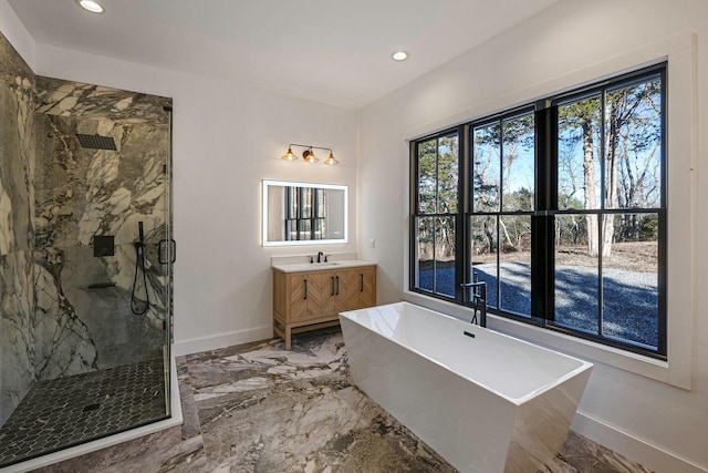 bathroom with vanity and independent shower and bath