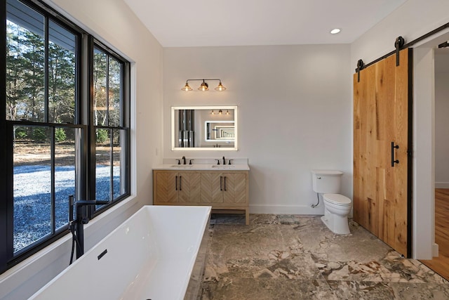 bathroom with vanity, toilet, wood-type flooring, and a tub to relax in