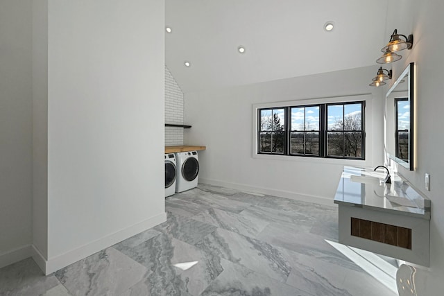 washroom with washer and clothes dryer and sink