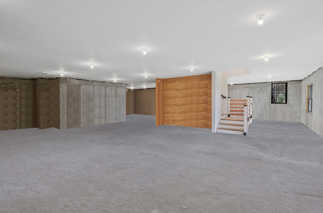 basement featuring light colored carpet