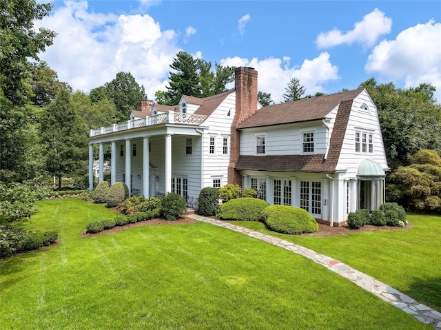 rear view of property with a yard