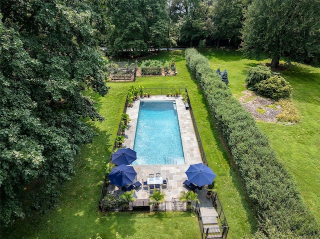 view of pool featuring a lawn and a patio area