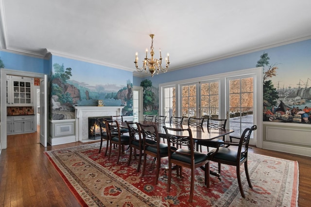 dining room featuring dark hardwood / wood-style flooring, a high end fireplace, ornamental molding, and a notable chandelier