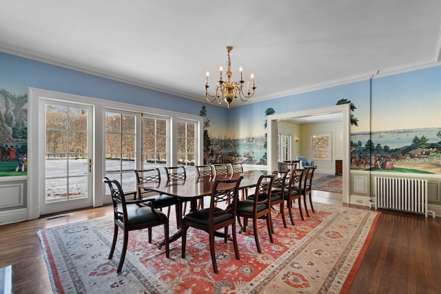 dining room featuring hardwood / wood-style floors, radiator heating unit, crown molding, and a chandelier