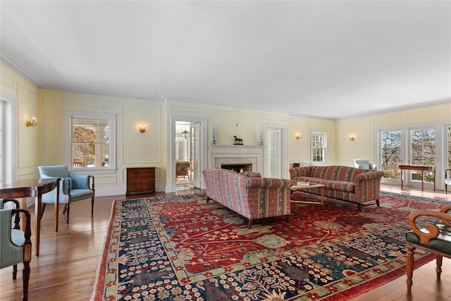 living room featuring hardwood / wood-style floors and ornamental molding