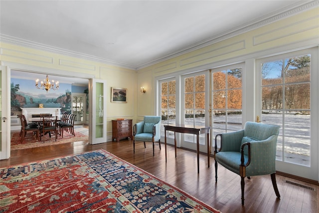 sunroom / solarium featuring an inviting chandelier