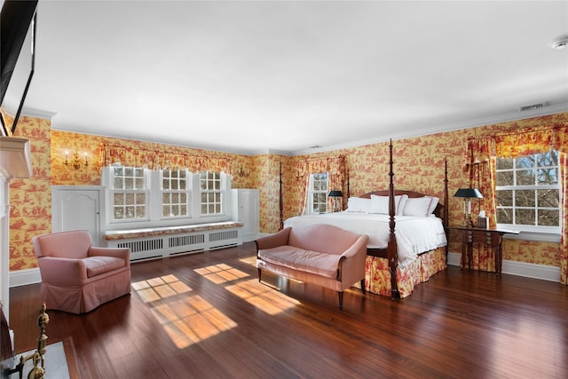 bedroom with crown molding, dark hardwood / wood-style floors, and radiator heating unit