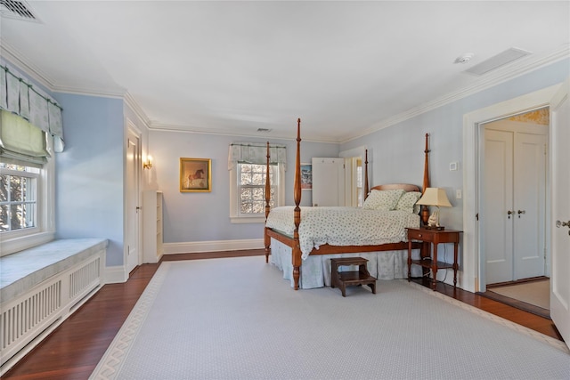 bedroom with radiator, crown molding, and hardwood / wood-style flooring