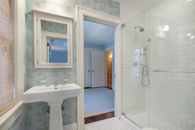 bathroom featuring an enclosed shower and crown molding