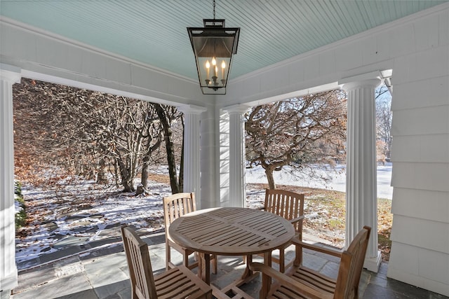 sunroom featuring a chandelier