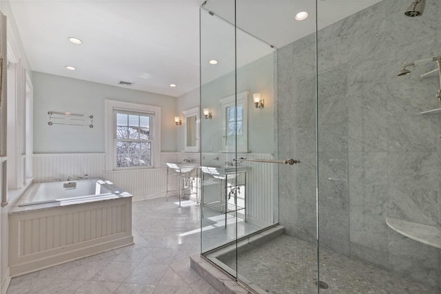 36 Revolutionary Rd, Briarcliff Manor, NY 10510 - full bath featuring marble tiled flooring, a bath, a tile shower, wainscoting, and a decorative wall