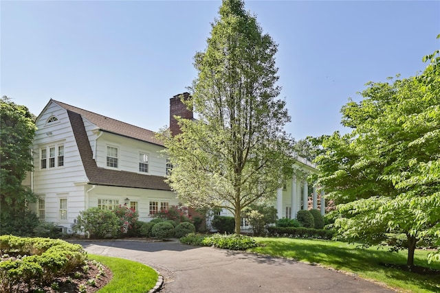36 Revolutionary Rd, Briarcliff Manor, NY 10510 - view of front of house with a chimney, roof with shingles, and driveway