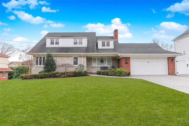 view of front of house featuring a front yard and a garage