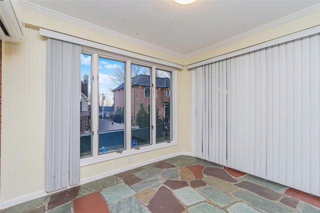 spare room featuring ornamental molding and a wall mounted AC