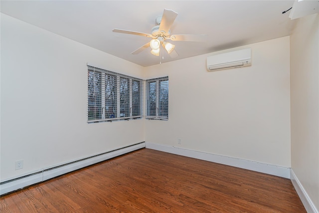 spare room featuring hardwood / wood-style flooring, an AC wall unit, baseboard heating, and ceiling fan