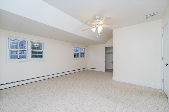 spare room featuring a baseboard radiator, vaulted ceiling, and ceiling fan