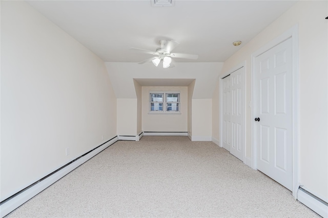 unfurnished room featuring ceiling fan, baseboard heating, and vaulted ceiling