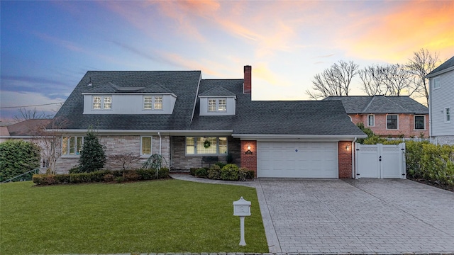 view of front facade with a garage and a yard