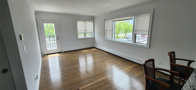 interior space featuring hardwood / wood-style flooring, crown molding, and a baseboard radiator