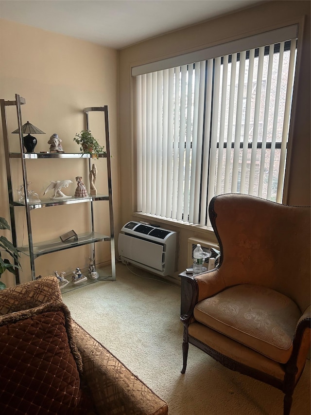 sitting room featuring carpet flooring and a wall mounted air conditioner