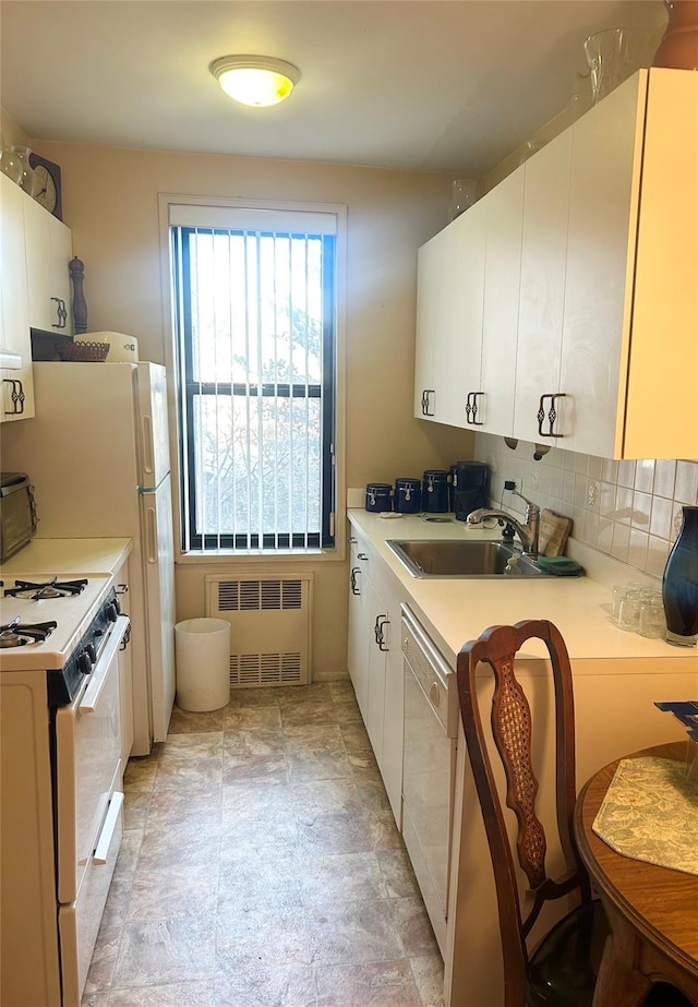 kitchen with white cabinetry, white appliances, radiator, and tasteful backsplash