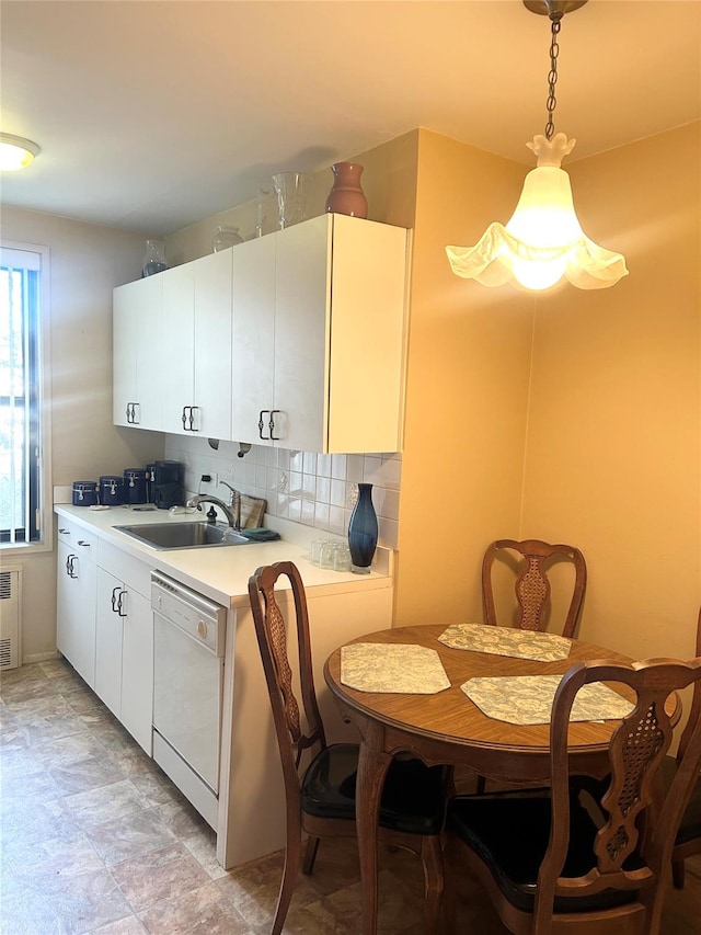 kitchen with pendant lighting, dishwasher, sink, decorative backsplash, and white cabinetry