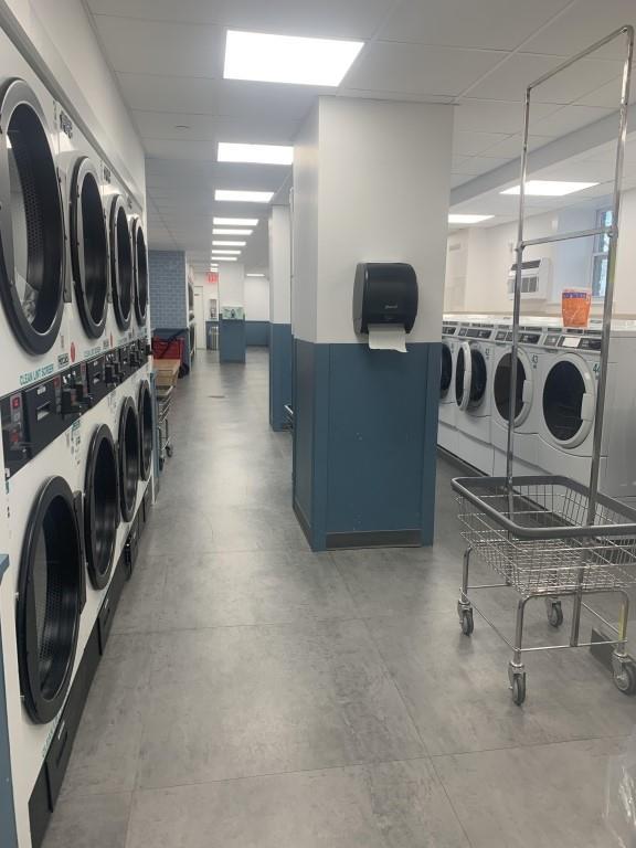 laundry room with washing machine and clothes dryer and stacked washer and dryer