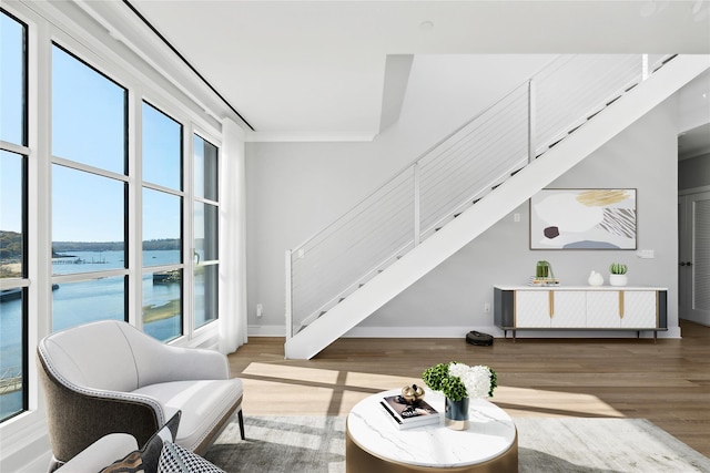 living room featuring hardwood / wood-style flooring and a water view