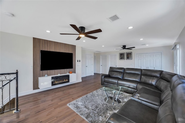 living room featuring ceiling fan and hardwood / wood-style flooring