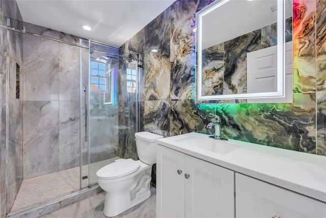 bathroom with an enclosed shower, vanity, toilet, and tile walls