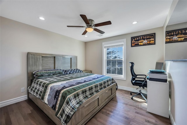 bedroom with ceiling fan and hardwood / wood-style flooring