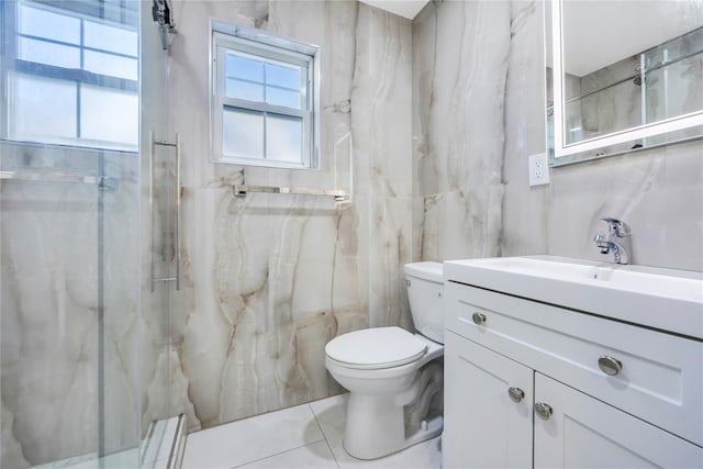 bathroom featuring vanity, toilet, tiled shower, and tile walls