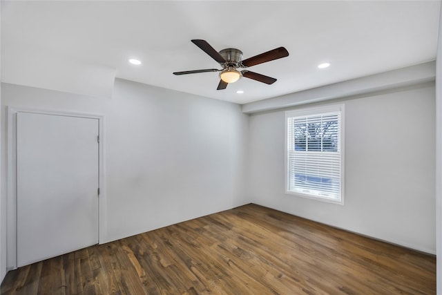 unfurnished room featuring ceiling fan and dark wood-type flooring