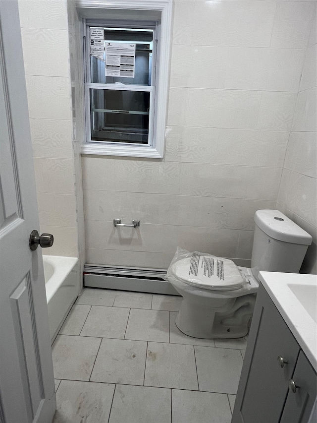 bathroom with vanity, baseboard heating, a bath, tile patterned flooring, and toilet