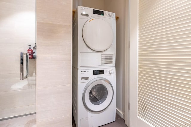 washroom with stacked washer and dryer