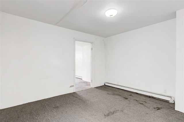 unfurnished room featuring carpet floors and a baseboard heating unit