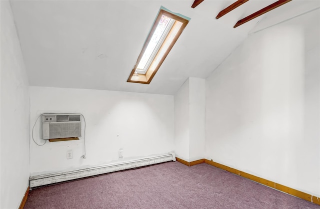 additional living space featuring carpet, a baseboard radiator, an AC wall unit, and vaulted ceiling with skylight