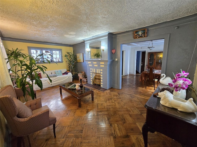 living room with dark parquet flooring, ornamental molding, and a textured ceiling