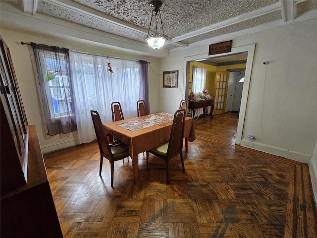 dining space with dark parquet flooring and french doors