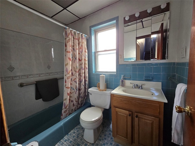 full bathroom with vanity, tile patterned flooring, toilet, tile walls, and shower / tub combo