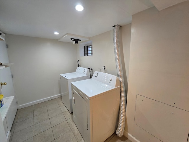 laundry area featuring light tile patterned flooring and separate washer and dryer