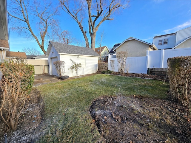 view of yard with a garage and an outdoor structure