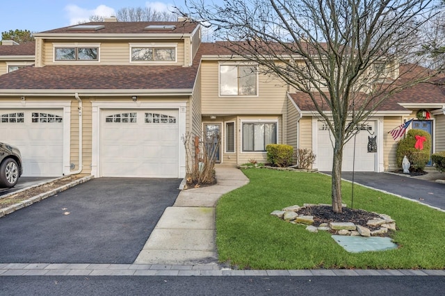 view of front of home with a garage and a front lawn