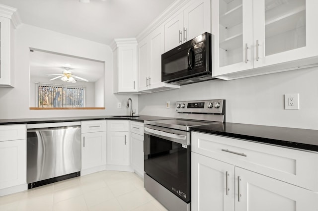 kitchen with white cabinets, stainless steel appliances, ceiling fan, and sink