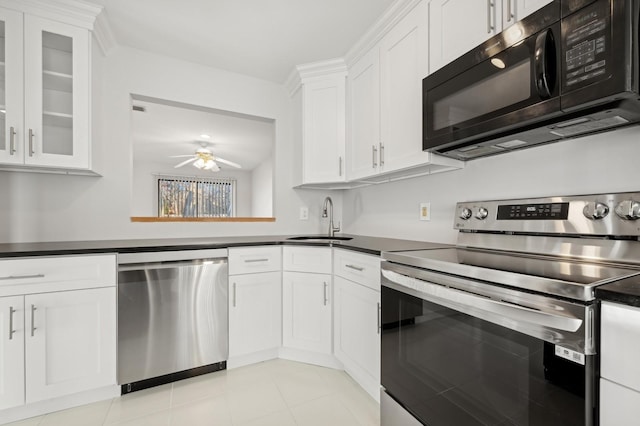 kitchen with white cabinets, sink, ceiling fan, light tile patterned floors, and appliances with stainless steel finishes