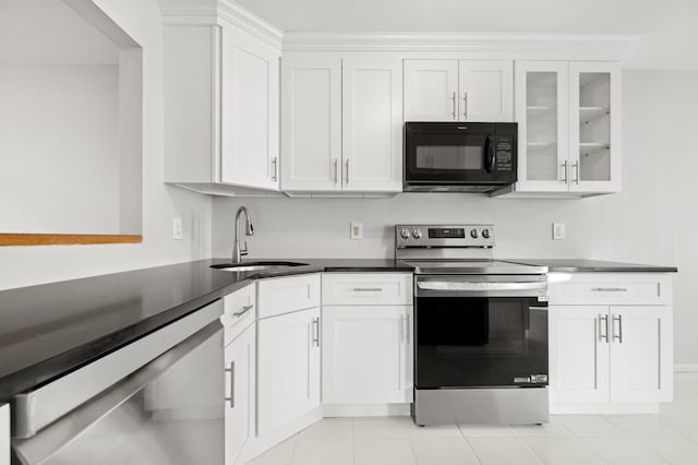 kitchen with white cabinets, light tile patterned floors, stainless steel appliances, and sink