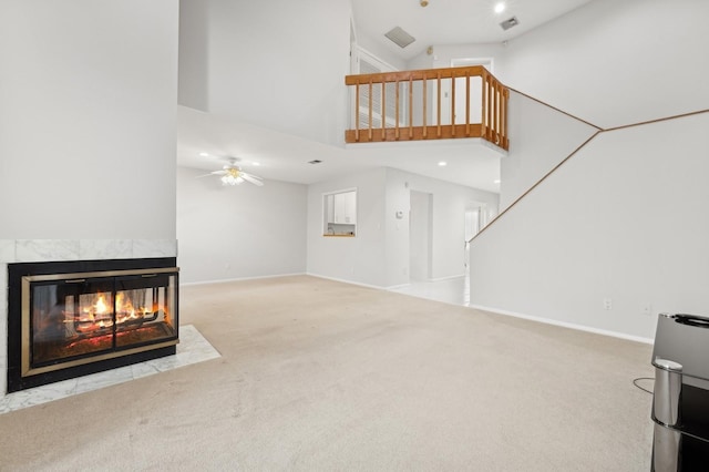 unfurnished living room with ceiling fan, a multi sided fireplace, carpet floors, and high vaulted ceiling