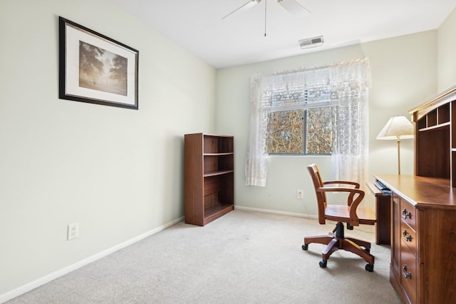 carpeted office space with ceiling fan